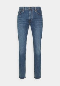 Jeans i denim med en medelblå tvätt, med design i rak ben, fem fickor och en knappstängning vid midjan.