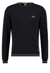 Pull-over noir à manches longues, col rond et poignets côtelés. Présente des accents blancs au col et à l'ourlet, avec un petit logo sur la poitrine.