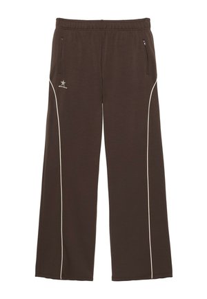Pantalon de survêtement marron à larges jambes avec liseré blanc sur les côtés, taille élastique et poches zippées des deux côtés.