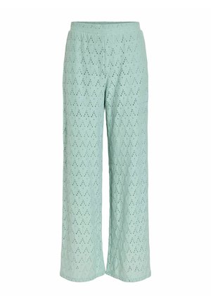Pantalon large vert clair avec un motif losange ajouré et une taille élastique.