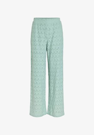 Pantalon large vert clair avec un motif losange ajouré et une taille élastique.