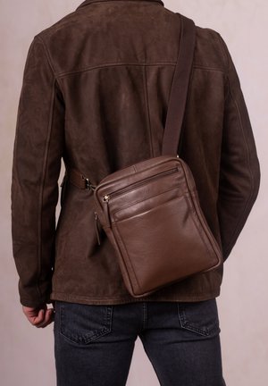 Brown leather crossbody bag with a smooth texture, featuring two zippered pockets and a single adjustable strap.