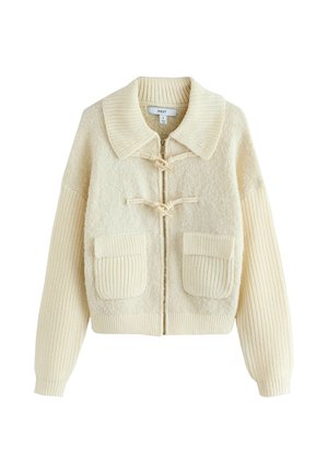 Cream-colored cardigan with a textured body, ribbed sleeves, large pockets, and toggle closures. Features a wide, round collar and zipper.