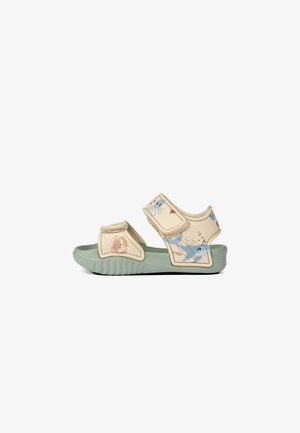 Children's sandals with a cream upper featuring ocean-themed illustrations, adjustable Velcro straps, and a green rubber sole.