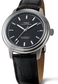Timex Waterbury automatic watch with a black dial, silver-tone hour markers, and a round stainless steel case. Black leather strap with textured pattern.