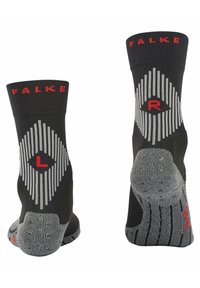 Calcetines tobilleros negros con suelas grises texturizadas. Presentan letras rojas "L" y "R" para el pie izquierdo y derecho, con un patrón de diamantes en rayas grises.