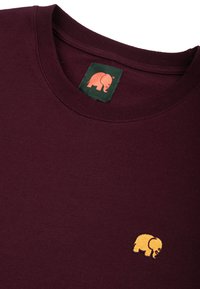 Bordeaux bavlněná mikina s kulatým výstřihem a malým žlutým slonem vyšitým na levé části hrudi. Hladká textura, ležérní design.