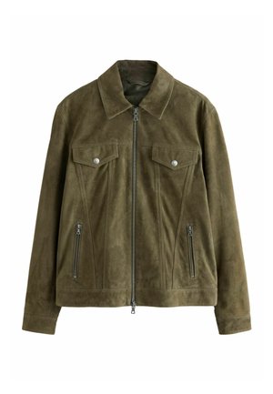 Alyvuogių žalios spalvos zomšinė striukė su priekiu užtraukiamu užtrauktuku, dviem krūtinės kišenėmis su atvartais ir mygtukais bei dviem vertikaliomis šoninėmis kišenėmis su užtrauktukais.