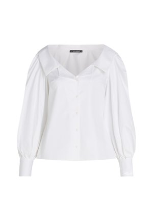 Valge nööpidega särk laia kraega, puhviga pikad varrukad ja koomaldatud talje. Siledast puuvillakangast, millel on peen sära.