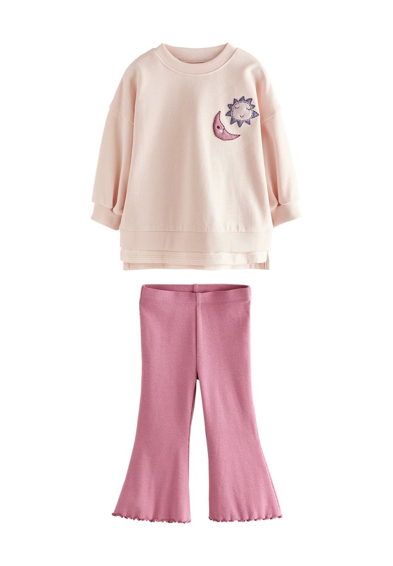 Pink cotton sweatshirt with a sun and moon embroidery, paired with ribbed pink flared pants featuring a scalloped hem.