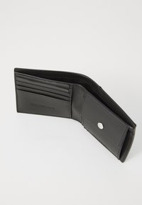 Black leather wallet with multiple card slots and a snap-button closure. Features a smooth texture with a subtle brand logo embossed.