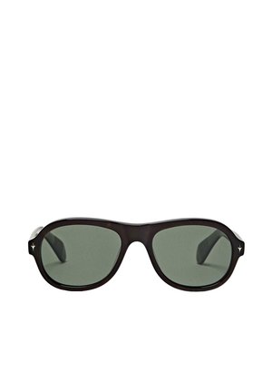 Lunettes de soleil ovales noires avec des verres vert foncé et de petits détails en forme d'étoile argentée sur les bords de la monture.