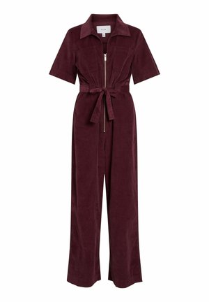Burgundy corduroy jumpsuit featuring short sleeves, a zip front, two chest pockets, a belted waist, and wide leg design.