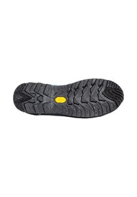 Black Vibram sole with deep treads and white specks, featuring a logo, designed for traction and durability. Curved edge for comfort.