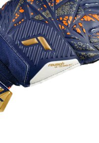 Guanto da portiere di colore blu navy con accenti arancioni e dorati. Caratterizzato da una superficie di presaTexture e cuciture rinforzate per una maggiore durata. Logo del marchio incluso.