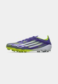 Purple and lime green cleat with white stripes, laces, and studs on a plain background.