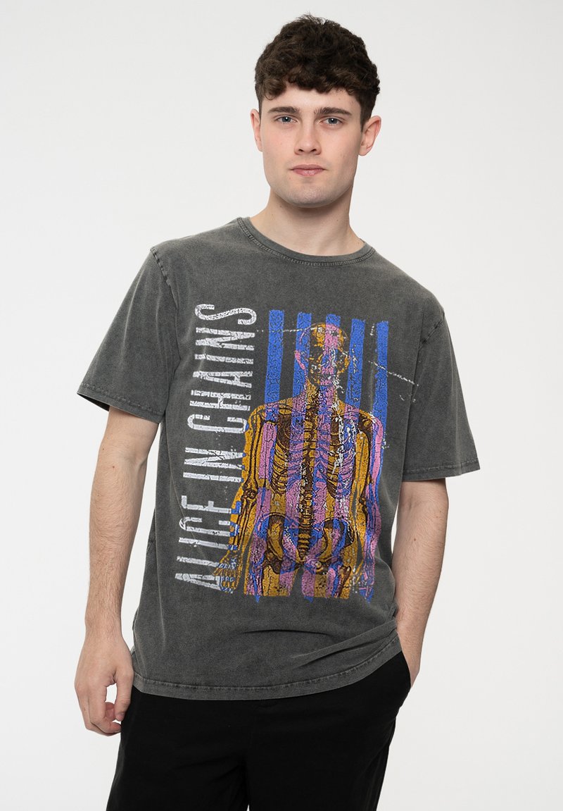 Gray short-sleeve t-shirt with distressed seams, featuring a colorful graphic design of a skeleton and text "ALICE IN CHAINS" in bold font.