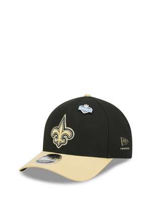 Black and beige New Era cap with a fleur-de-lis logo front, NFL Draft badge on top, and New Era logo on the side.