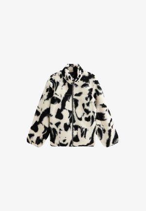 Wollen zwart-witte ritsjas met hoge kraag, voorzien van een abstract patroon en een ontspannen pasvorm. Zachte textuur met lange mouwen.