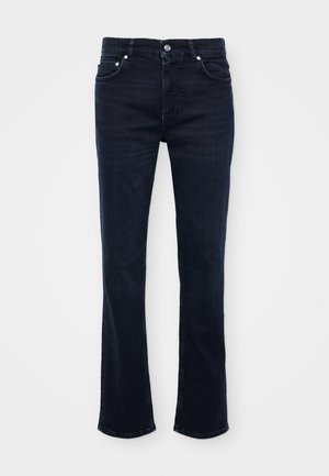 Donkerblauwe, uitlopende jeans van denim, met een sluiting aan de voorkant, vijf zakken en strakke lijnen met subtiele stiknaden.