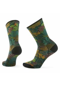 Calze alte fino al ginocchio con una base verde scuro caratterizzate da vivaci motivi di foglie in arancione, giallo e teal. Accenti neri sulla punta e sul tallone.