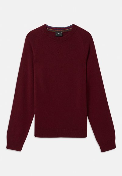 Burgundska jopica s okroglim izrezom, dolgimi rokavi in rebrastimi manšetami. Narejena iz mehkega materiala z teksturirano obdelavo in diskretnimi šivnimi detajli.