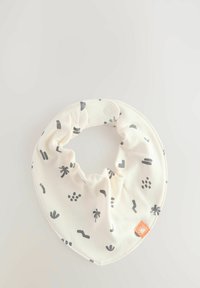 Bavoir en coton crème avec des motifs abstraits noirs et un bord texturé, doté d'une fermeture à pression et d'une petite étiquette orange.
