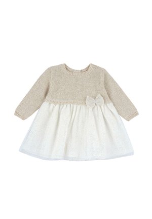 Beige knitted top with long sleeves; white skirt with gold polka dots; features a bow accent at the waist. Soft texture, round neckline.