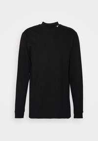 Black long-sleeve shirt with a high collar, made of smooth cotton fabric. Features a small white logo on the neckline.