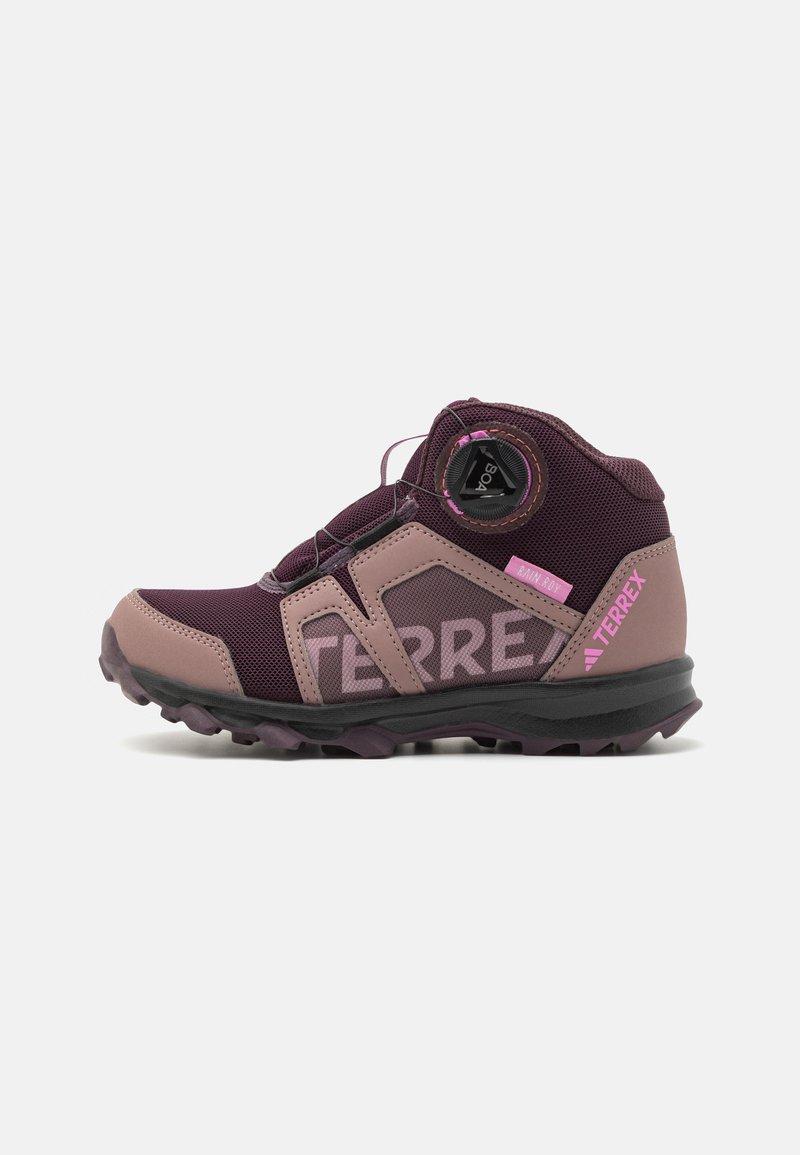 Purple and pink hiking shoe with mesh and synthetic materials, high ankle design, a Boa lacing system, and rugged outsole for traction.