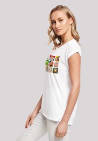 White cotton t-shirt featuring a colorful graphic with cartoon faces, short sleeves, and a relaxed fit. Smooth texture, simple silhouette.