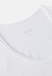 White tank top featuring a round neckline and textured fabric. Includes a small brand logo on the inner collar, crafted from soft material.