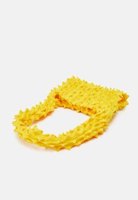 Yellow textured bag featuring a wavy, spiky design and a soft fabric composition. Compact shape with a unique, standout appearance.