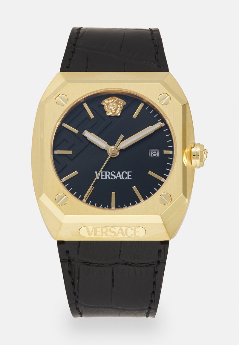 Kuldne oktagonaalne kell musta tekstuuriga sihvliga, Versace'i logo ja krooniga detail. Must nahkrihm nähtava õmblusega. Kuupäeva näitamine 3 ajal.