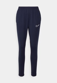 Pantaloni tuta blu navy realizzati in tessuto morbido, con un elastico in vita e il logo bianco di Nike sulla coscia sinistra.