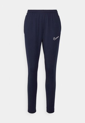 Pantalons de survêtement bleu marine en tissu doux, avec une taille élastique et un logo Nike blanc sur la cuisse gauche.
