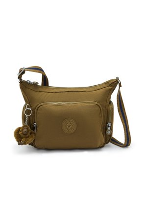 Sac bandoulière marron avec poche zippée à l'avant, sangle réglable rayée bleu et marron, et petit porte-clés singe en peluche attaché.