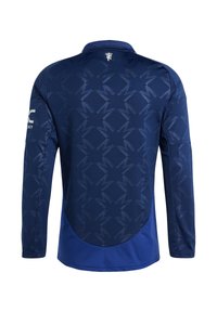 Langarm sportshirt in donkerblauw met een gestructureerd patroon. Heeft een kraag en een logo op de linker mouw. Glad stoffen afwerking.