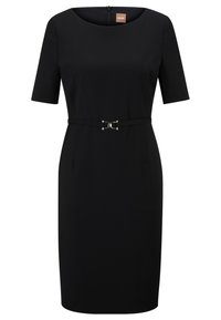 Black dress with short sleeves, fitted silhouette, and a round neckline. Features a decorative silver buckle on a matching belt.