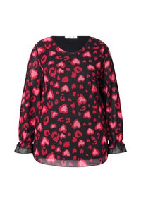 Blusa negra con un patrón de corazones rojos y rosas en una tela transparente. Mangas largas con puños elásticos y cuello redondo.