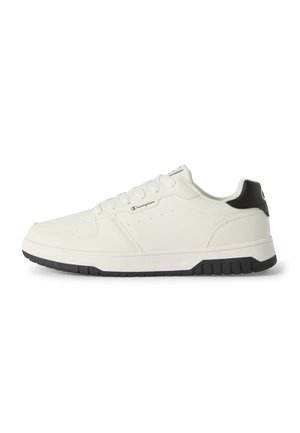 White low-top sneaker with black heel and sole, Champion logo on side, lace-up design, and textured details on sole and upper.