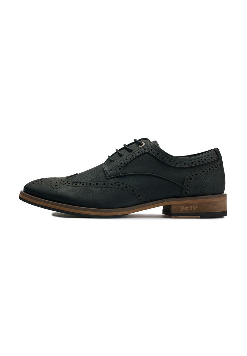 Black leather dress shoe with brogue detailing, lace-up design, rounded toe, and a light brown wooden heel. Subtle texture throughout.