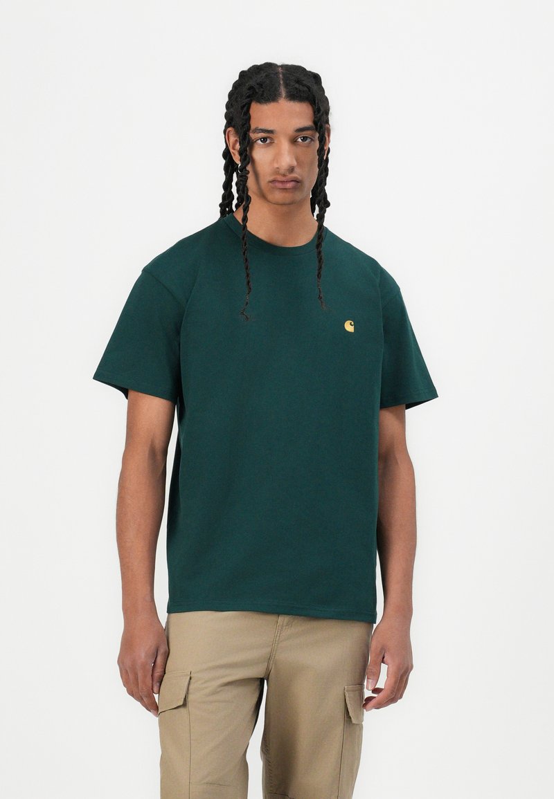 Dark green cotton T-shirt with a crew neckline and short sleeves, featuring a small, gold logo on the left chest.