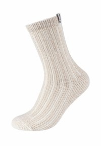 Lys beige ribbet sok lavet af blødt materiale, med en rund tå og et mærkeskilt ved ribben.