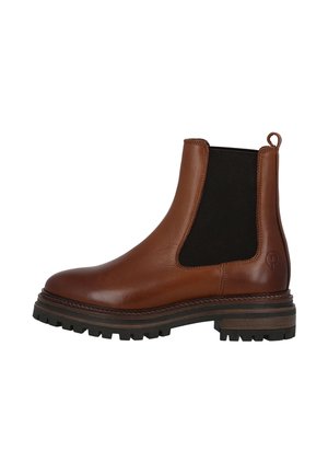 Bottines Chelsea en cuir brun avec des panneaux élastiques noirs sur les côtés, bout arrondi et semelle en caoutchouc texturé. Dotées d'une languette à l'arrière.