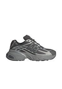 Γκρι αθλητικό παπούτσι με επάνω μέρος από πλέγμα, καουτσούκ σόλα και πολλαπλές υφασμάτινες επενδύσεις με υφή. Κορδόνια ενσωματωμένα στο σχέδιο για ασφαλές δέσιμο.