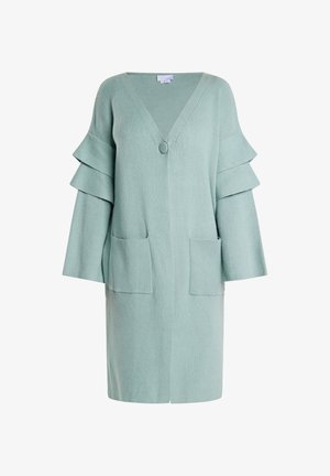 Heled roheline kaelakaelusega kardigan, nupuga kinnitamine, kaks eesmist taskut ja kihiline pitsilisest varrukatest koosnev disain. Pehme kudumitekstuur.