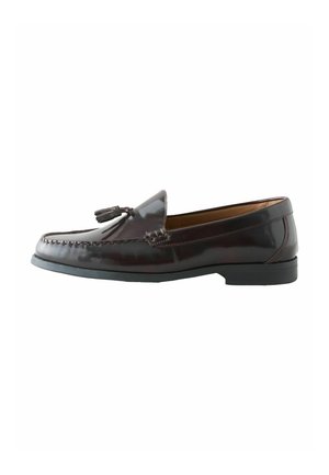 Dark brown leather tassel loafer with rounded toe, stitched detailing, and black rubber sole against white background.