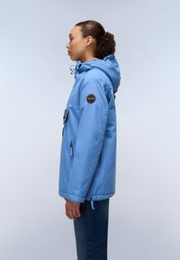 Light blue, water-resistant jacket with a hood, zippered pockets, and a patch on the sleeve, featuring a relaxed fit and smooth texture.