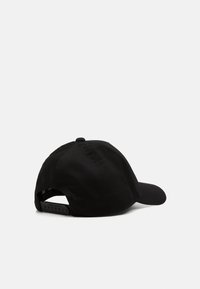 Cappellino da baseball nero con visiera curva, realizzato in tessuto liscia, dotato di una fascetta regolabile sul retro e una parte superiore arrotondata con dettagli cuciti.